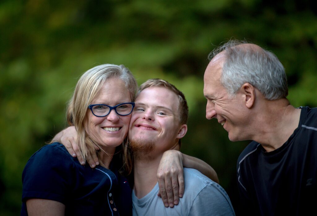 Two adults with a developmentally disabled young man. Two adults with a developmentally disabled young man.